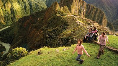 A group of people are standing on top of a mountain.