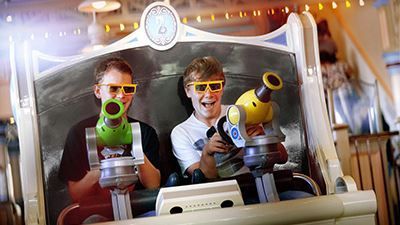 Two young boys wearing 3d glasses are riding a roller coaster.