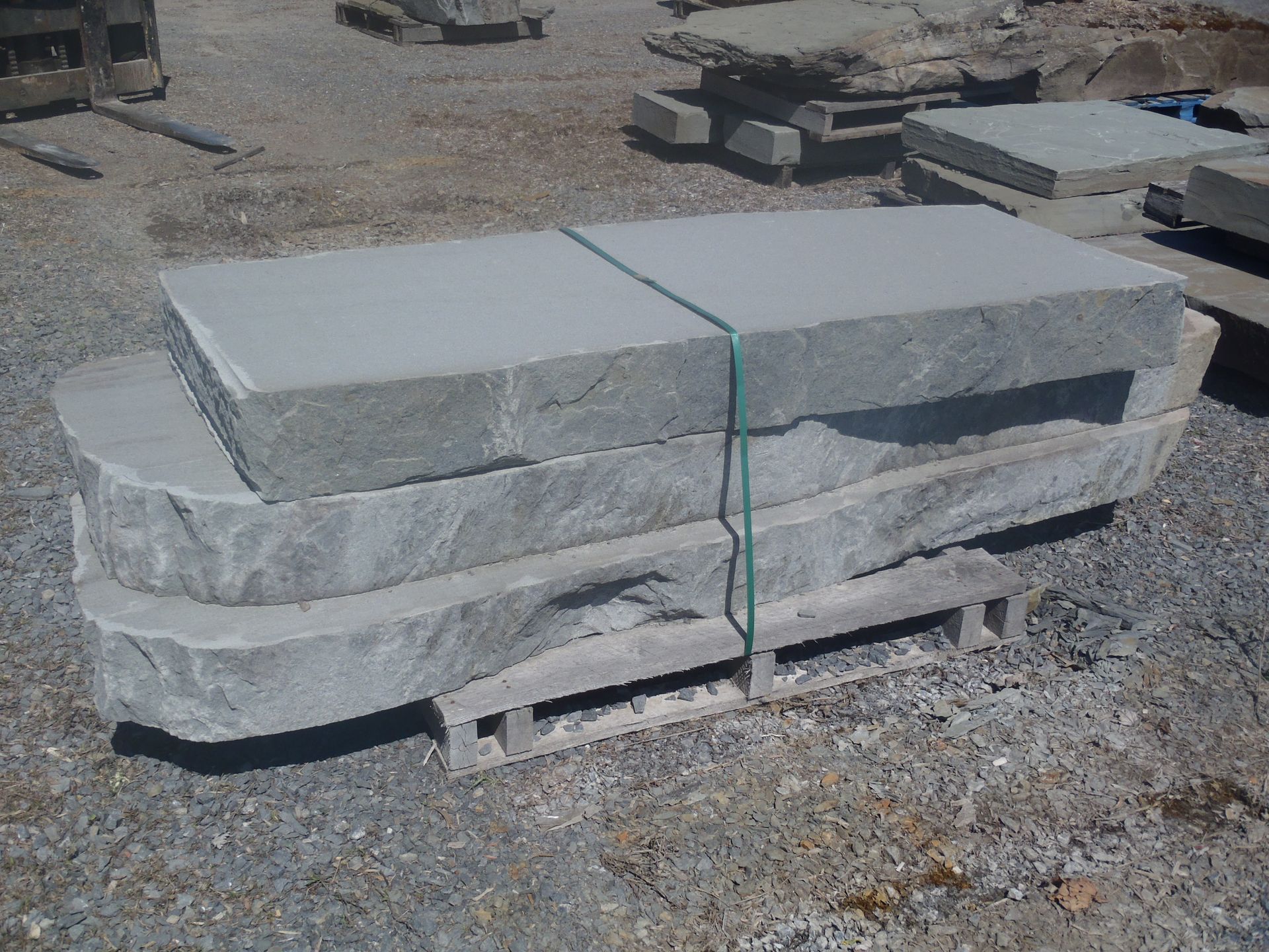a stack of concrete slabs sitting on top of a wooden pallet