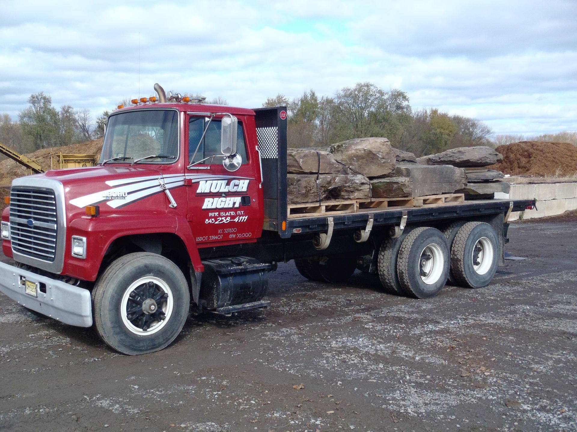 a red truck with the word mulch on the side