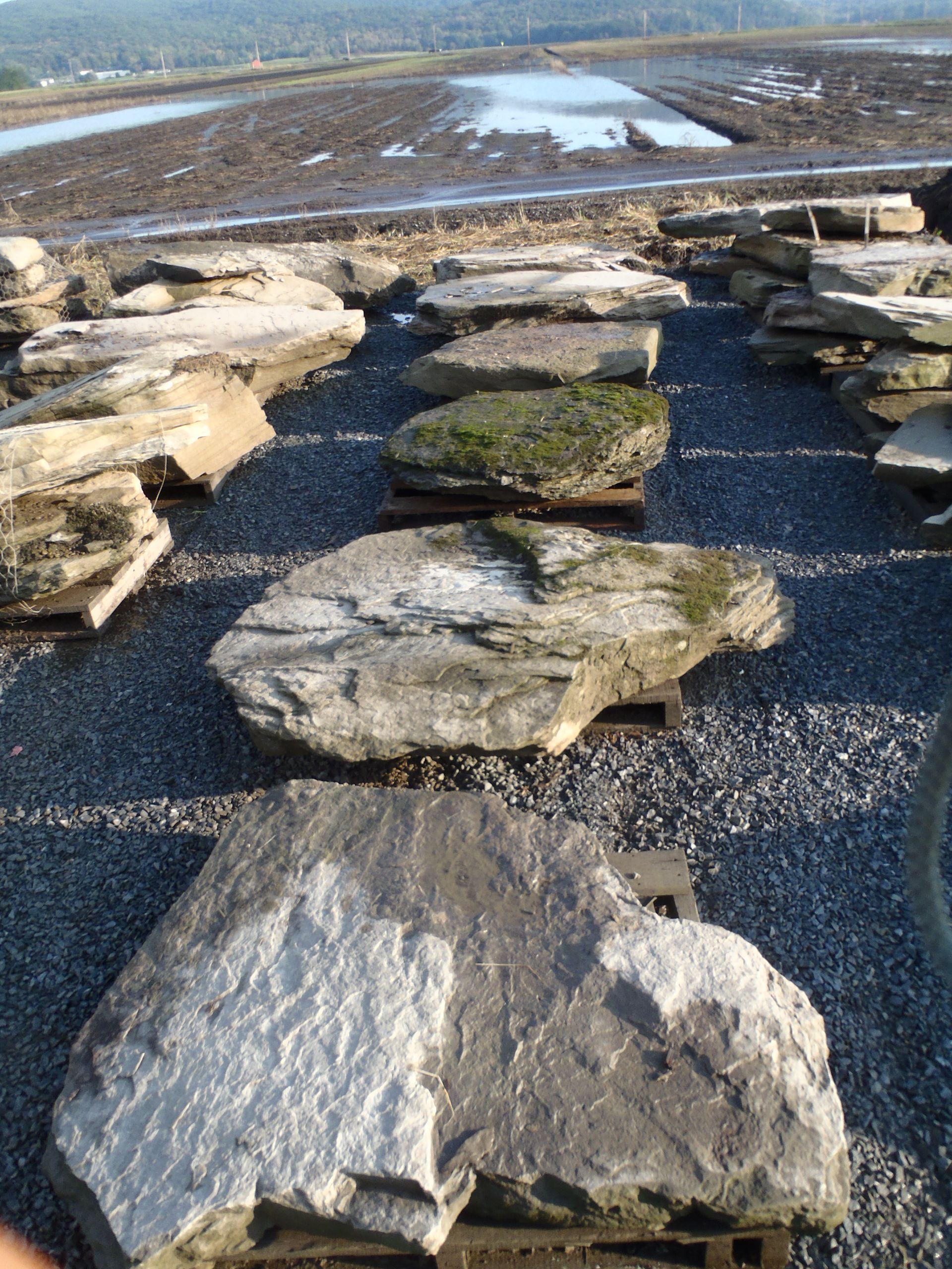 a pile of rocks sitting on top of a gravel road