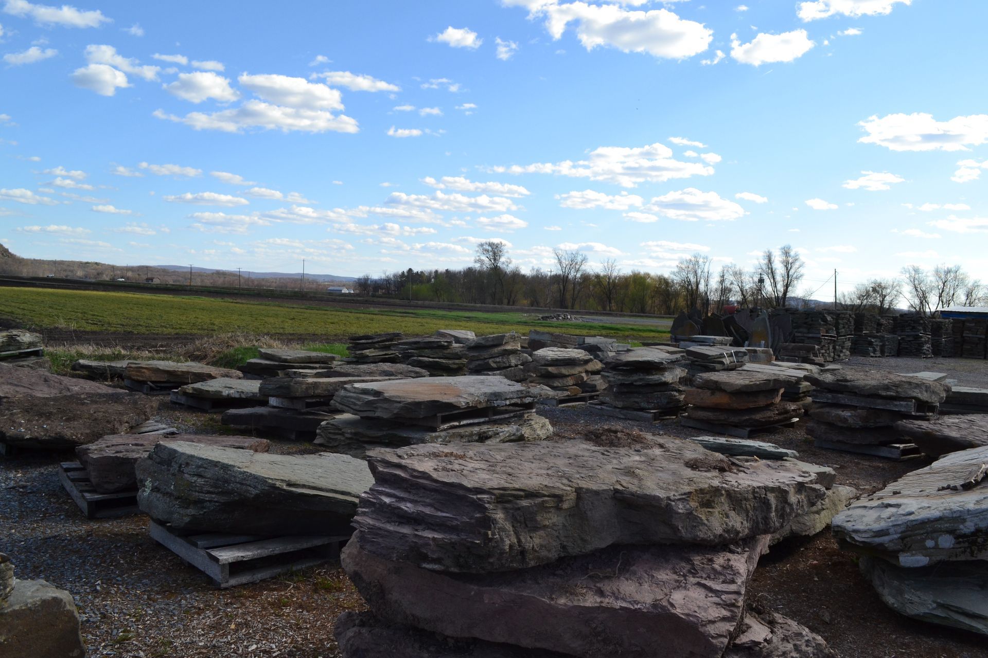 a pile of rocks sitting on top of each other in a field