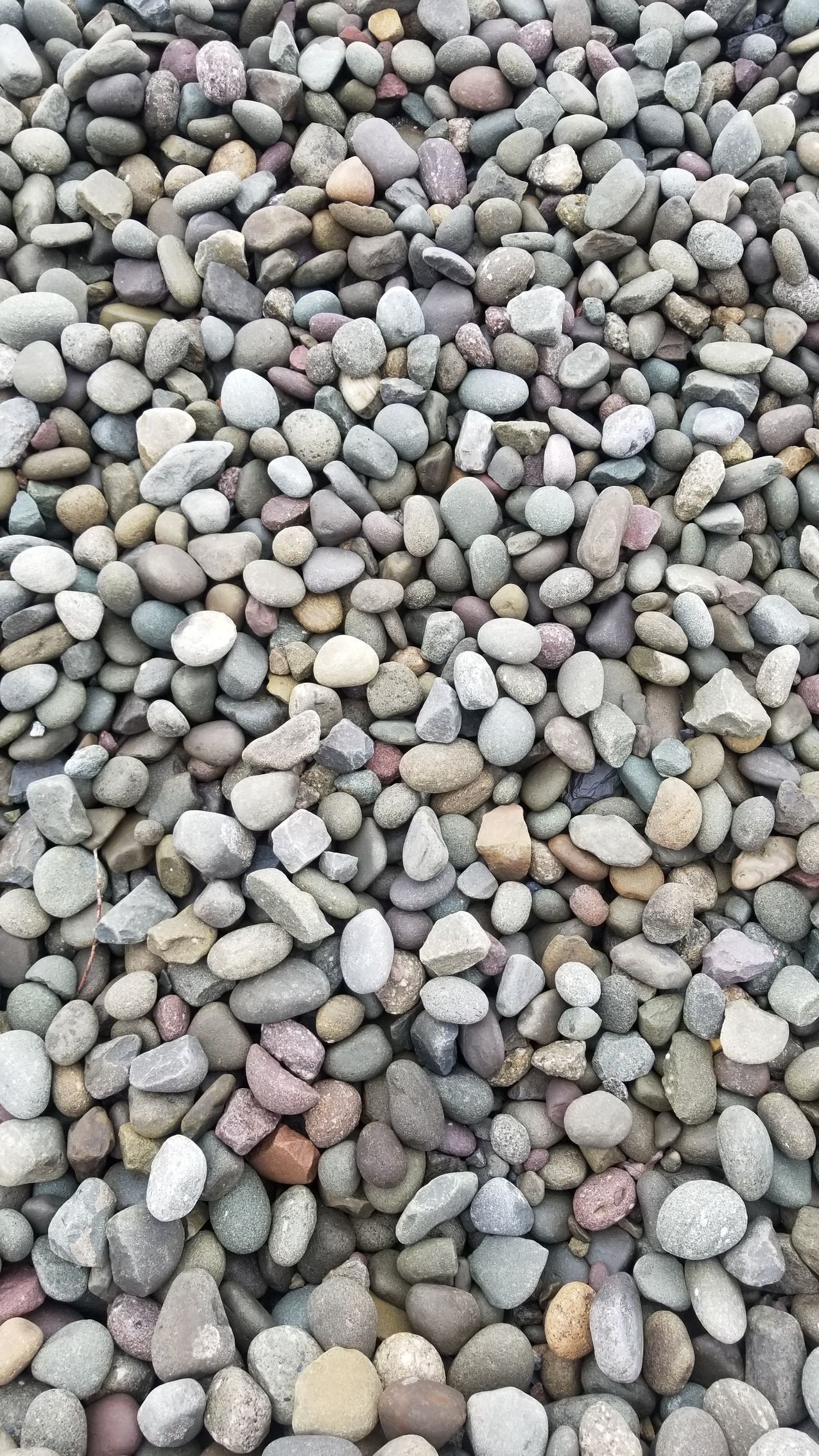 a pile of rocks sitting on top of each other on the ground