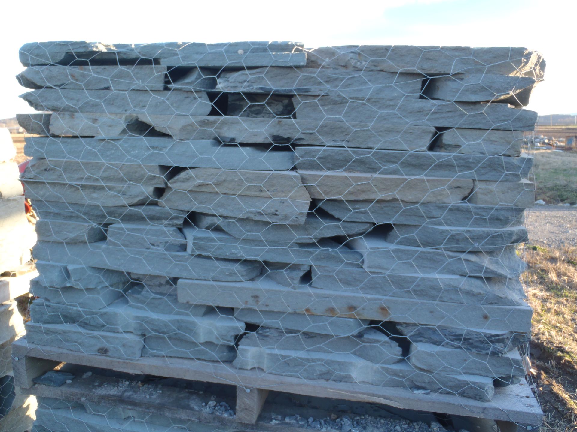 a pile of rocks stacked on top of each other on a wooden pallet