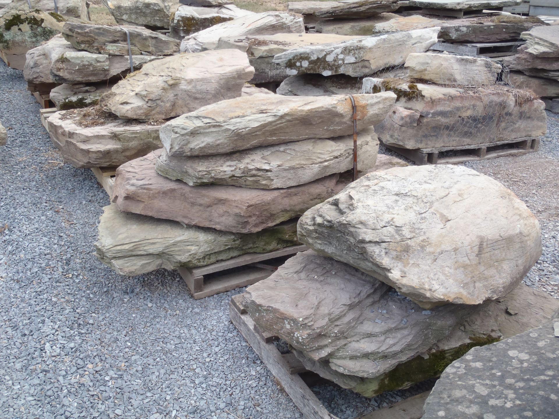 a pile of rocks stacked on top of each other on wooden pallets