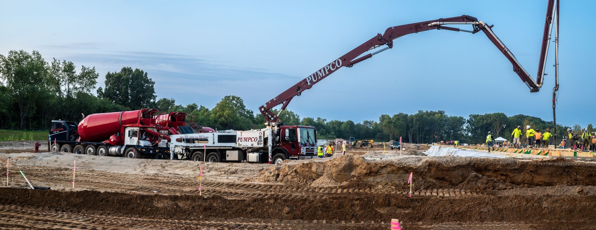 A concrete pump is being used to pour concrete on a construction site.