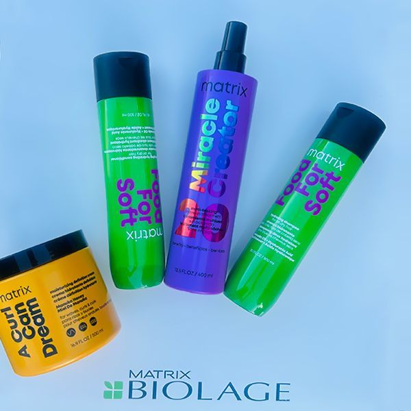 Hair care products from Matrix Biolage: four bottles, various colors, on a white surface.