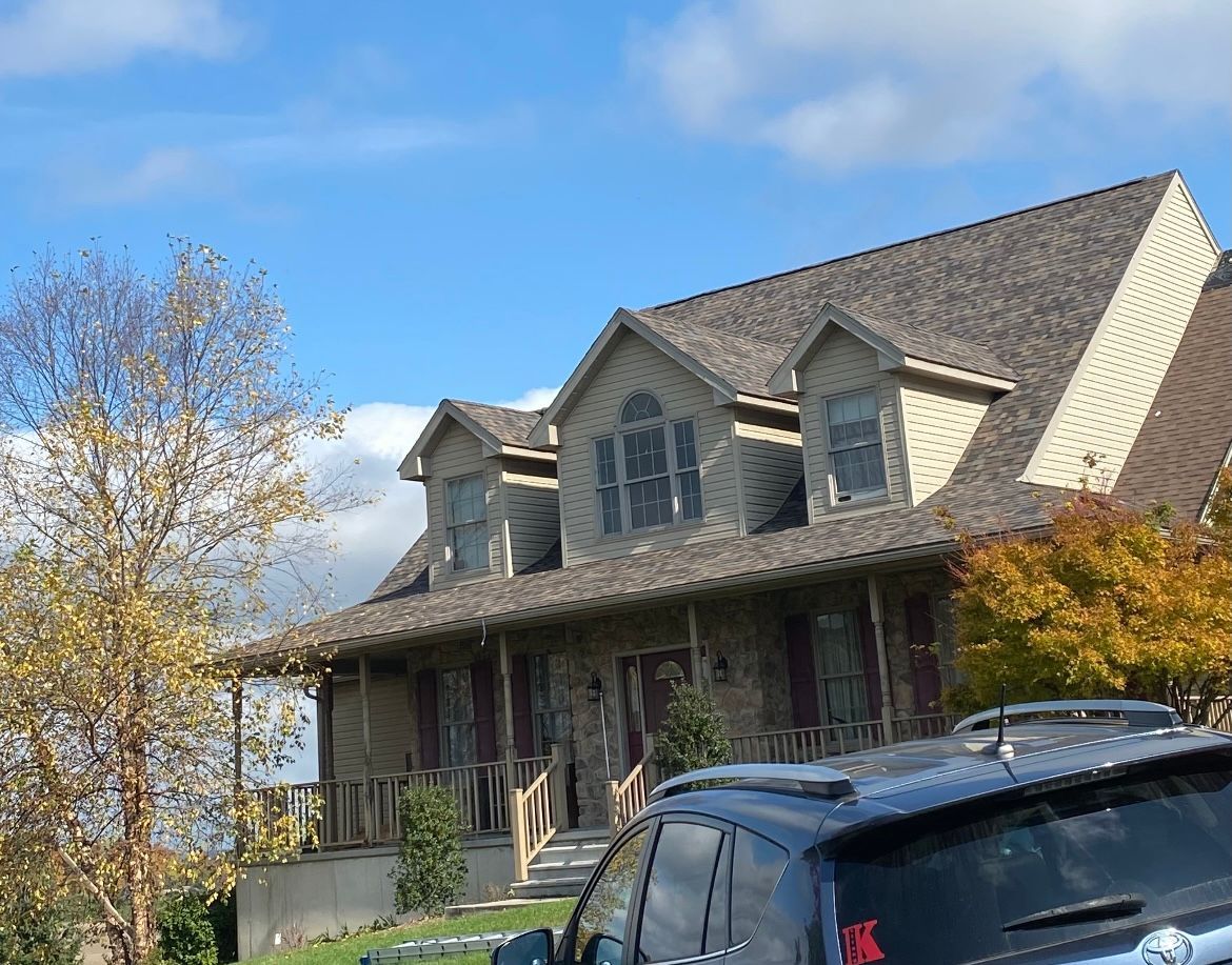 A large house with a car parked in front of it