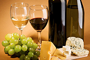 Grapes, wine, and cheese on a table