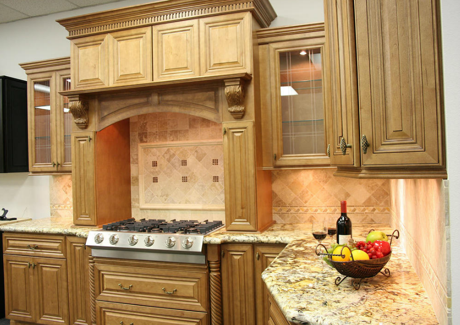 A kitchen with wooden cabinets and granite counter tops