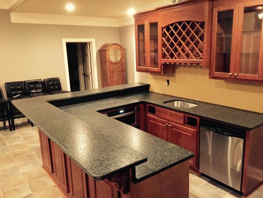 A kitchen with granite counter tops and stainless steel appliances