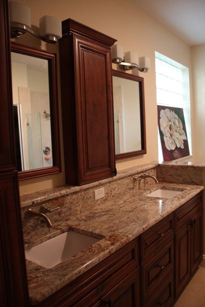A bathroom with two sinks and two mirrors