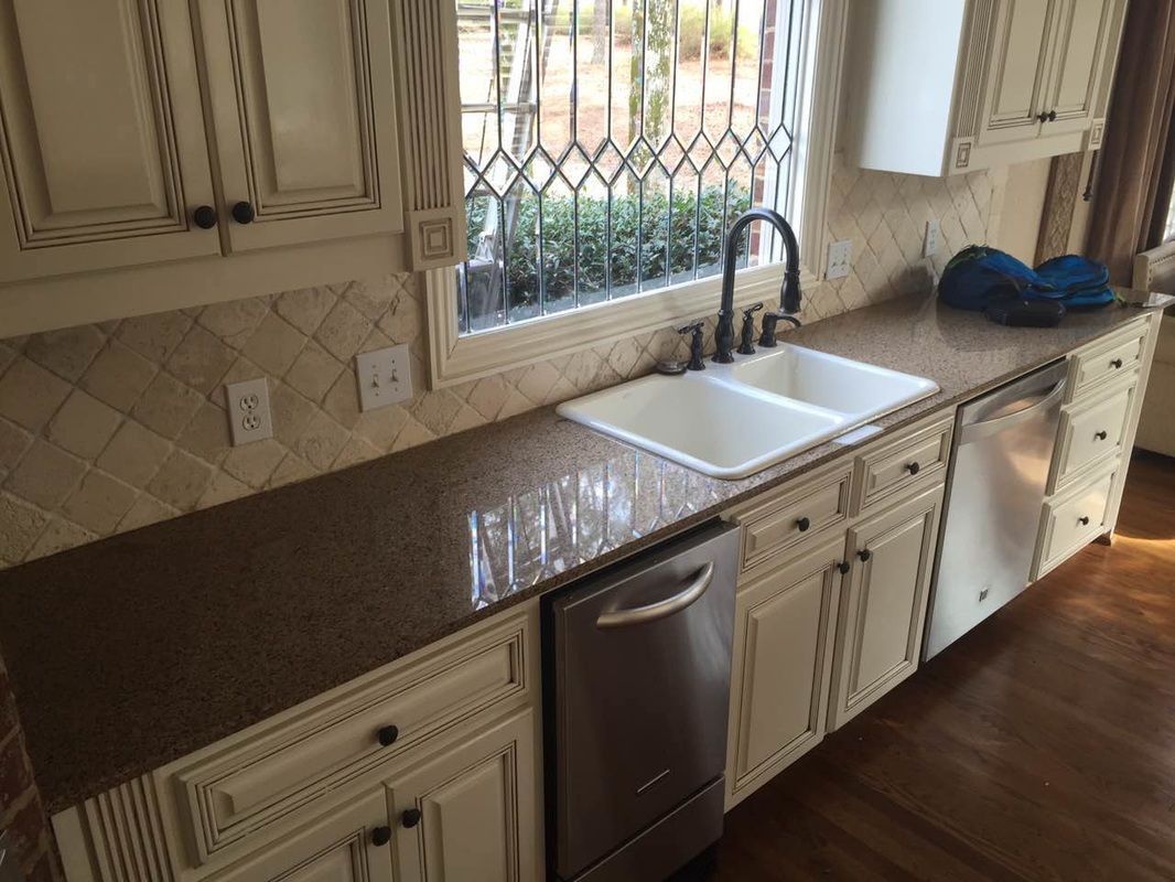 A kitchen with two sinks and a stainless steel dishwasher