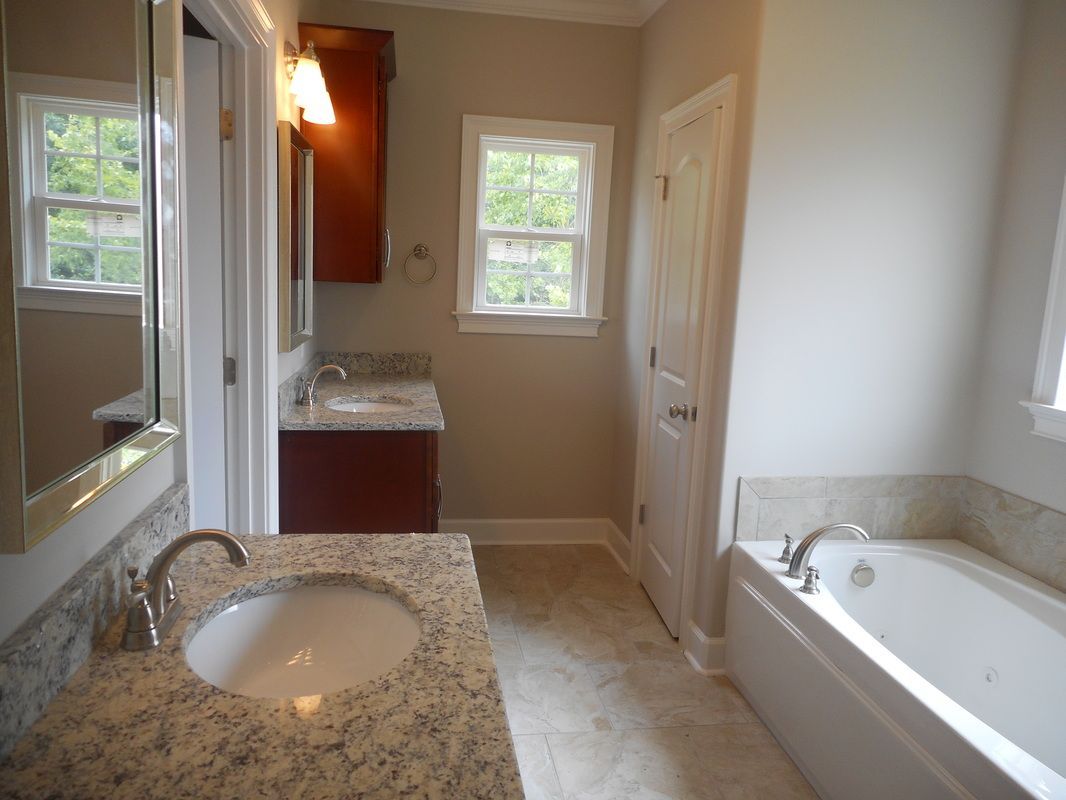 A bathroom with two sinks and a bathtub