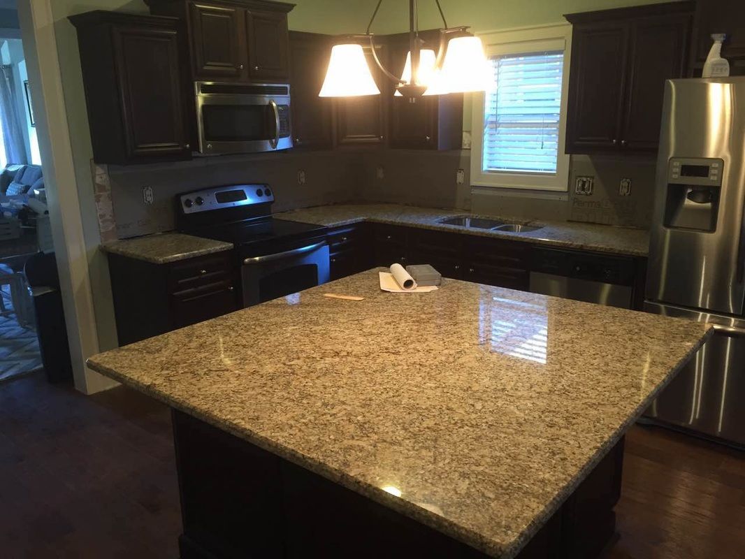 A kitchen with granite counter tops and stainless steel appliances