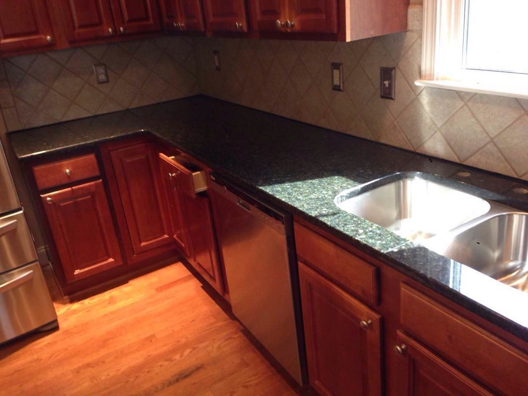A kitchen with stainless steel appliances and granite counter tops