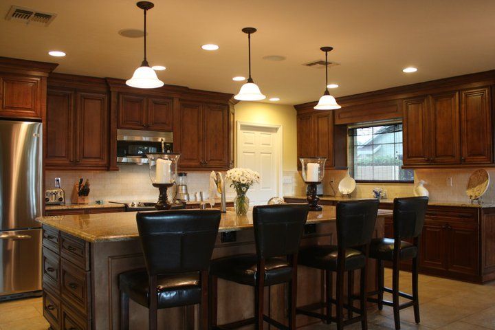A kitchen with wooden cabinets and stainless steel appliances