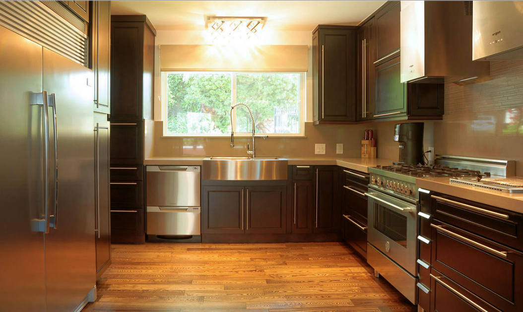 A kitchen with stainless steel appliances and wooden cabinets