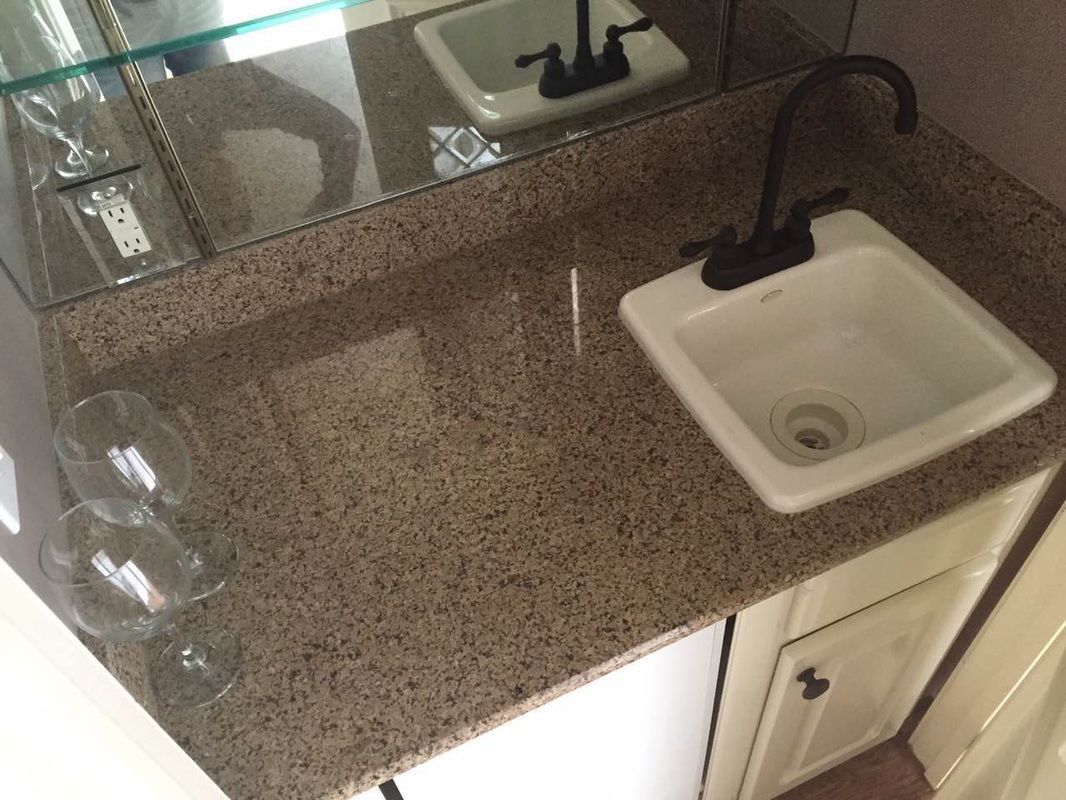 A bathroom counter with a sink and a mirror