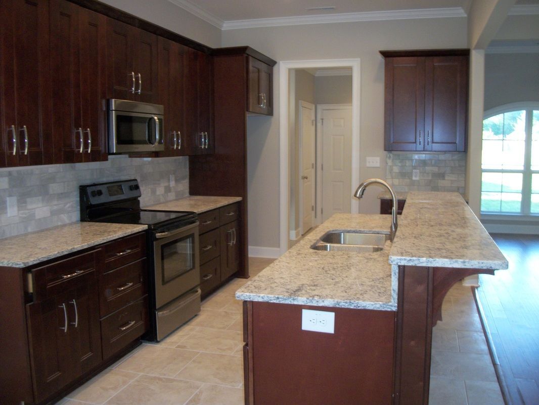 A kitchen with stainless steel appliances and granite counter tops