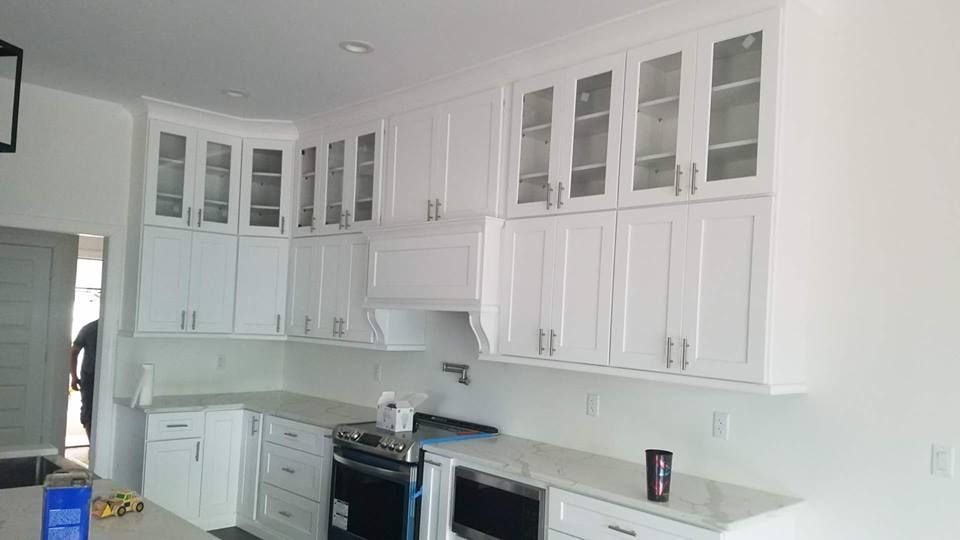A kitchen with white cabinets and stainless steel appliances.