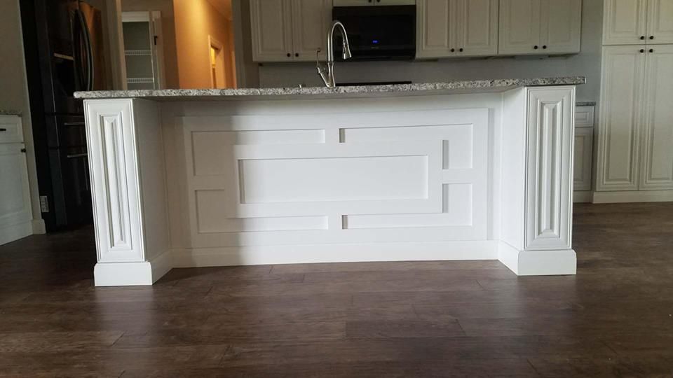 A kitchen with a large island in the middle of the room.