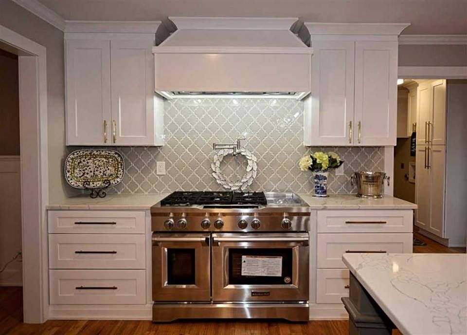 A kitchen with stainless steel appliances and white cabinets