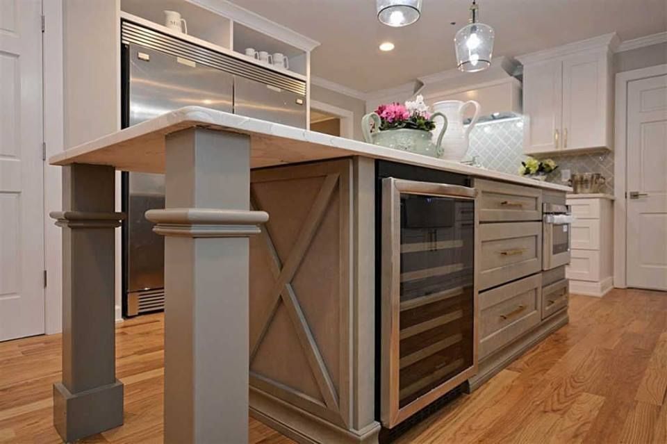 A kitchen with a large island and stainless steel appliances.
