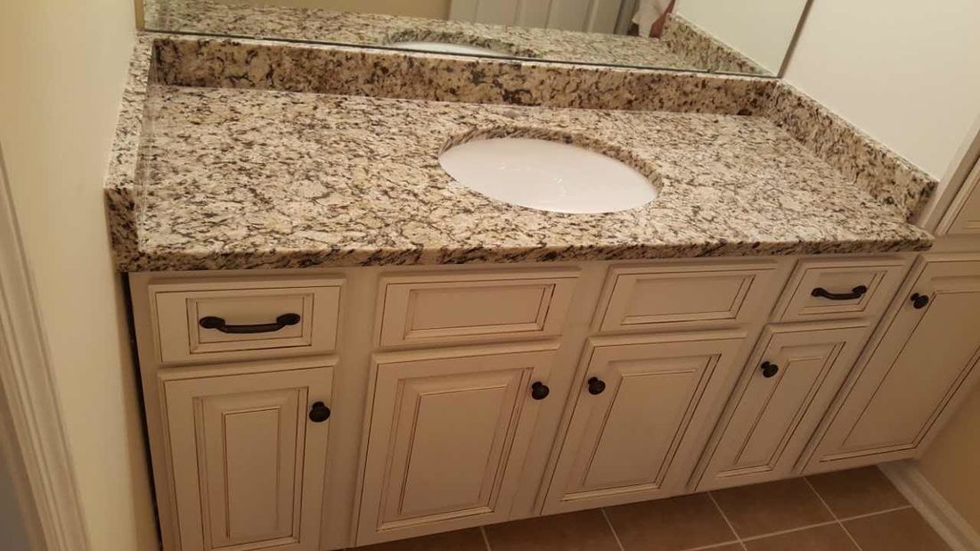 A bathroom vanity with a sink and a mirror.