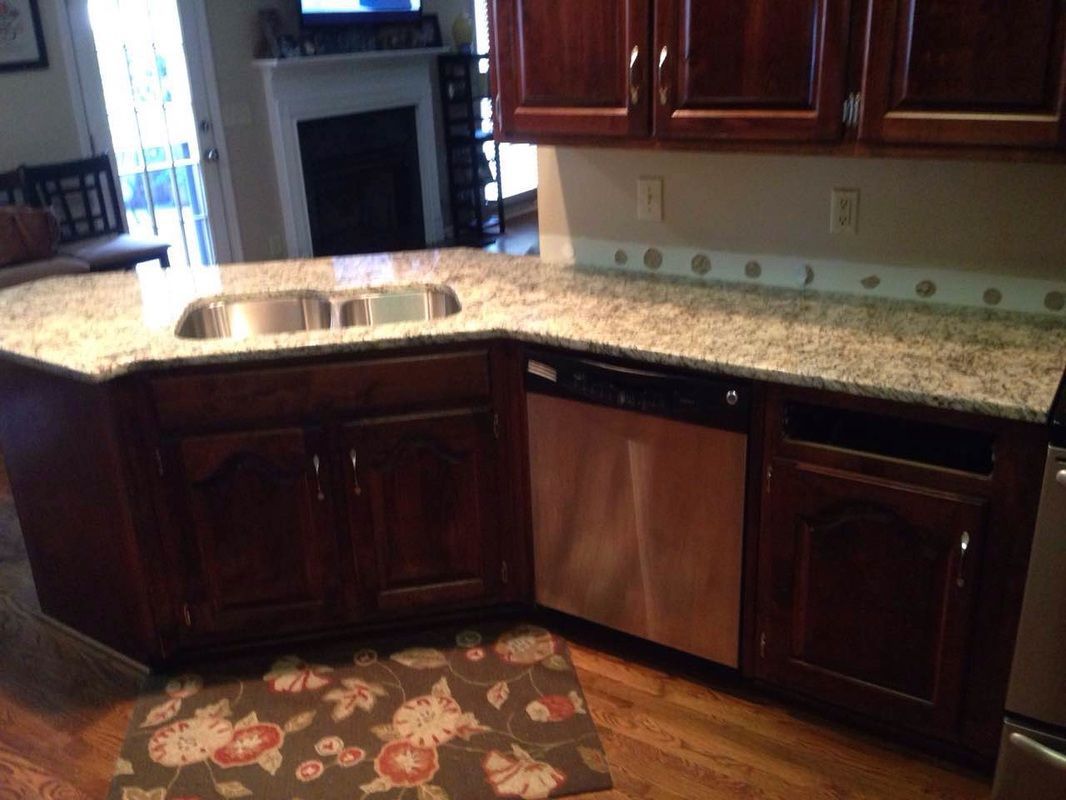 A kitchen with granite counter tops and stainless steel appliances