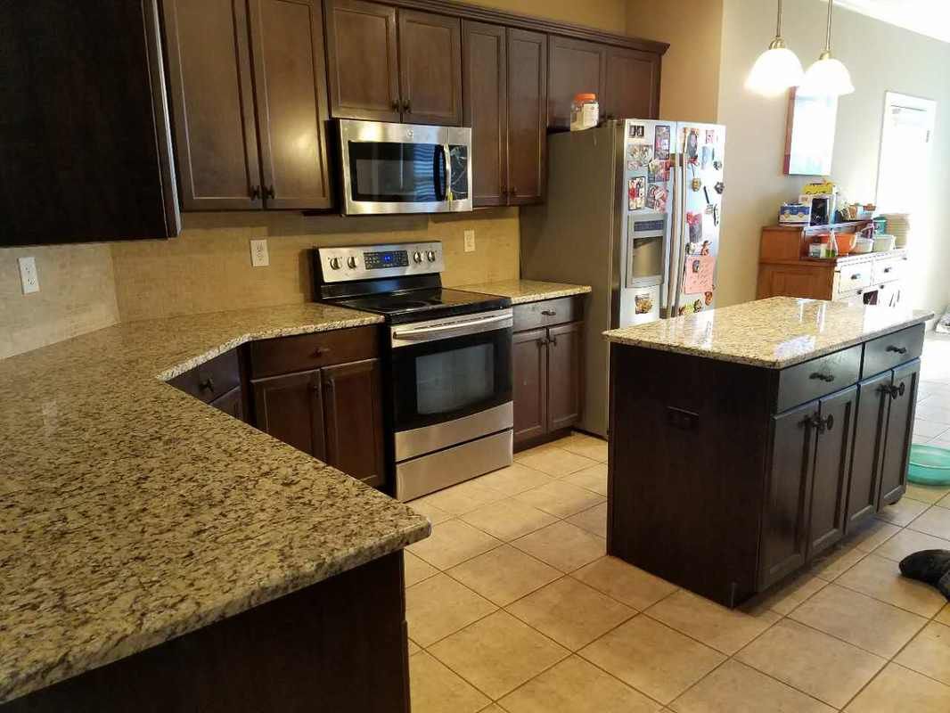 A kitchen with granite counter tops and stainless steel appliances