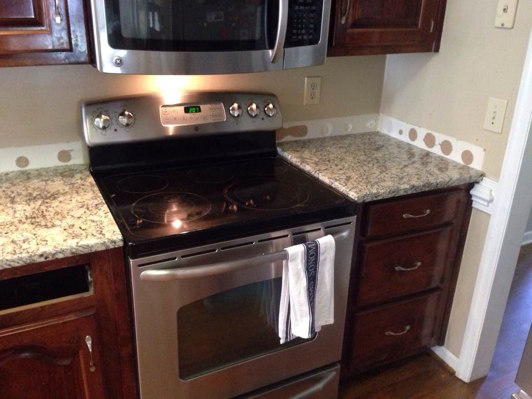 A kitchen with stainless steel appliances and granite counter tops