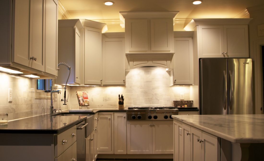 A kitchen with white cabinets and stainless steel appliances.