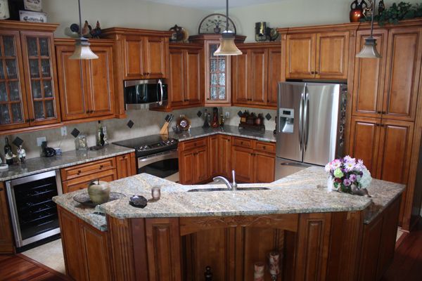 A kitchen with stainless steel appliances and wooden cabinets