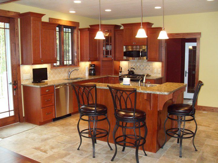 A kitchen with wooden cabinets and granite counter tops