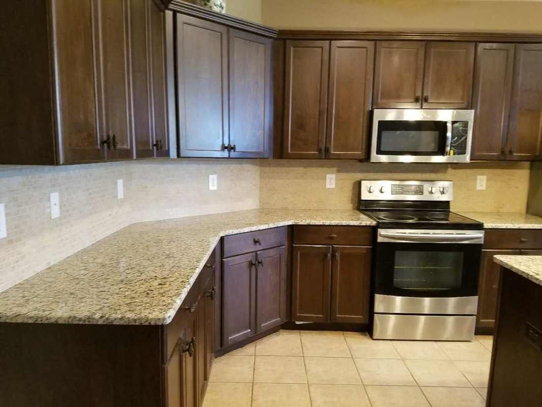 A kitchen with stainless steel appliances and granite counter tops