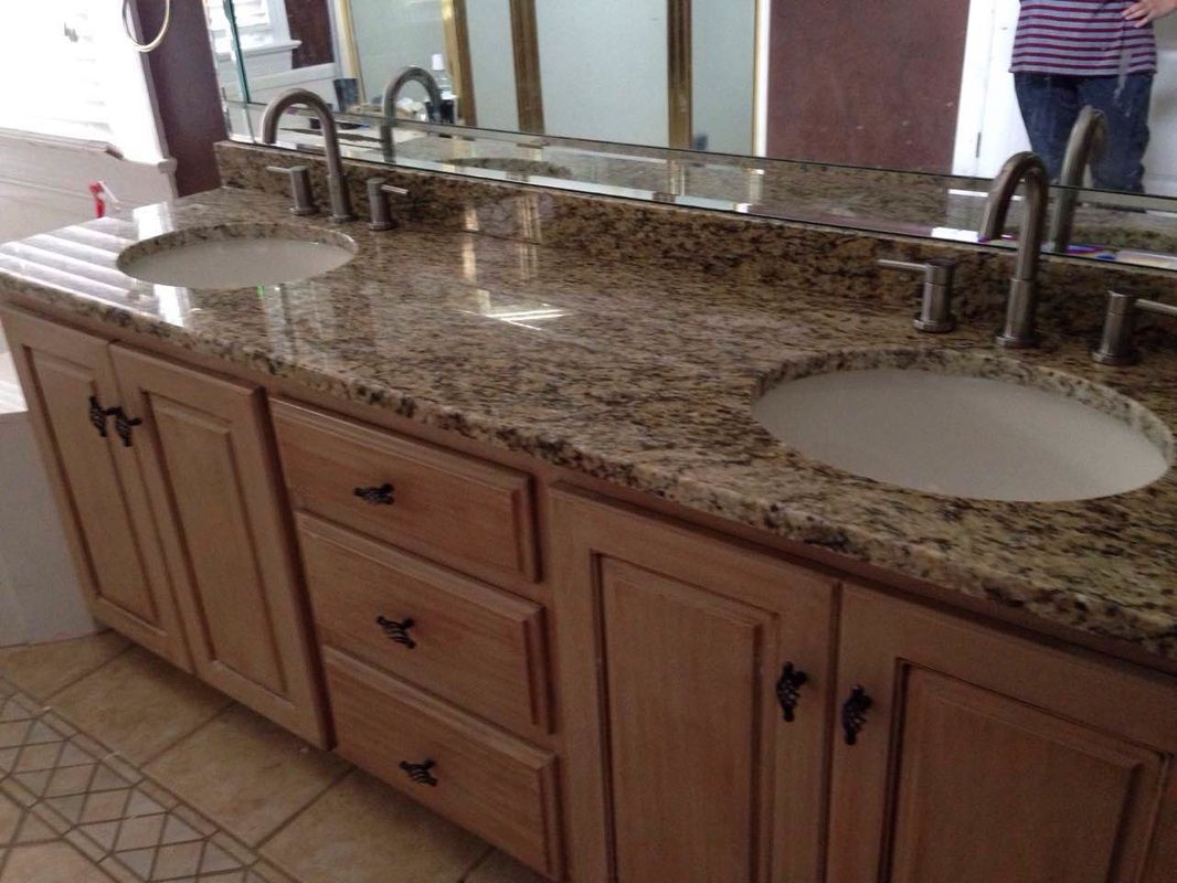 A bathroom with two sinks and a large mirror.