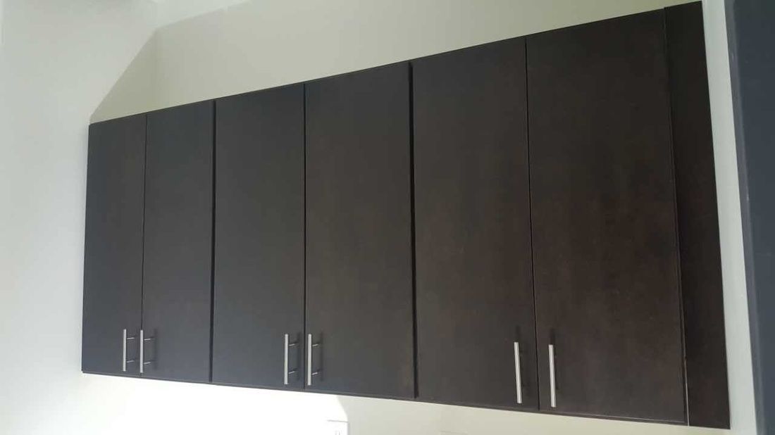 A kitchen with a lot of cabinets hanging from the ceiling.