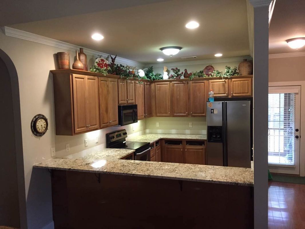 A kitchen with wooden cabinets and granite counter tops