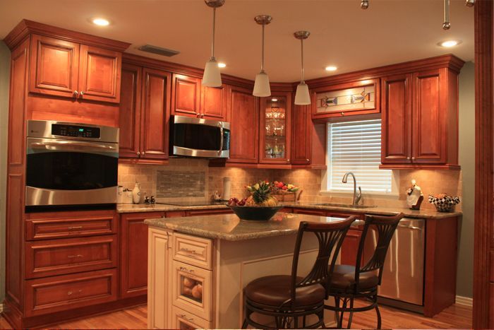 A kitchen with wooden cabinets and stainless steel appliances