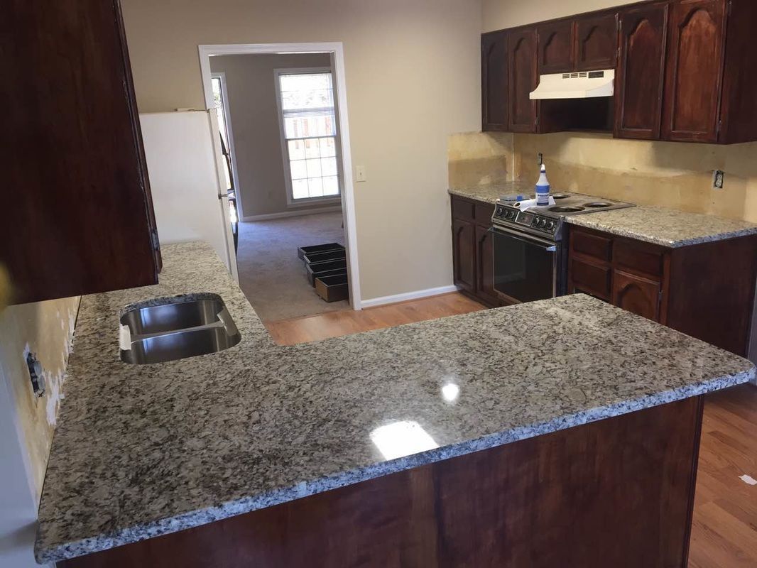A kitchen with granite counter tops and stainless steel appliances