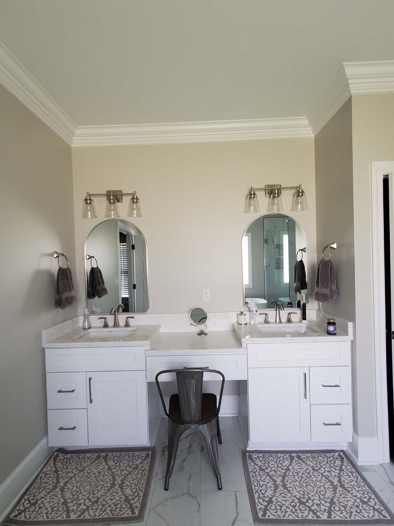 A bathroom with two sinks and two mirrors.