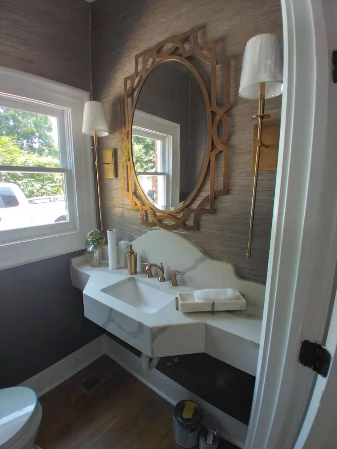 A bathroom with a sink , mirror and toilet.