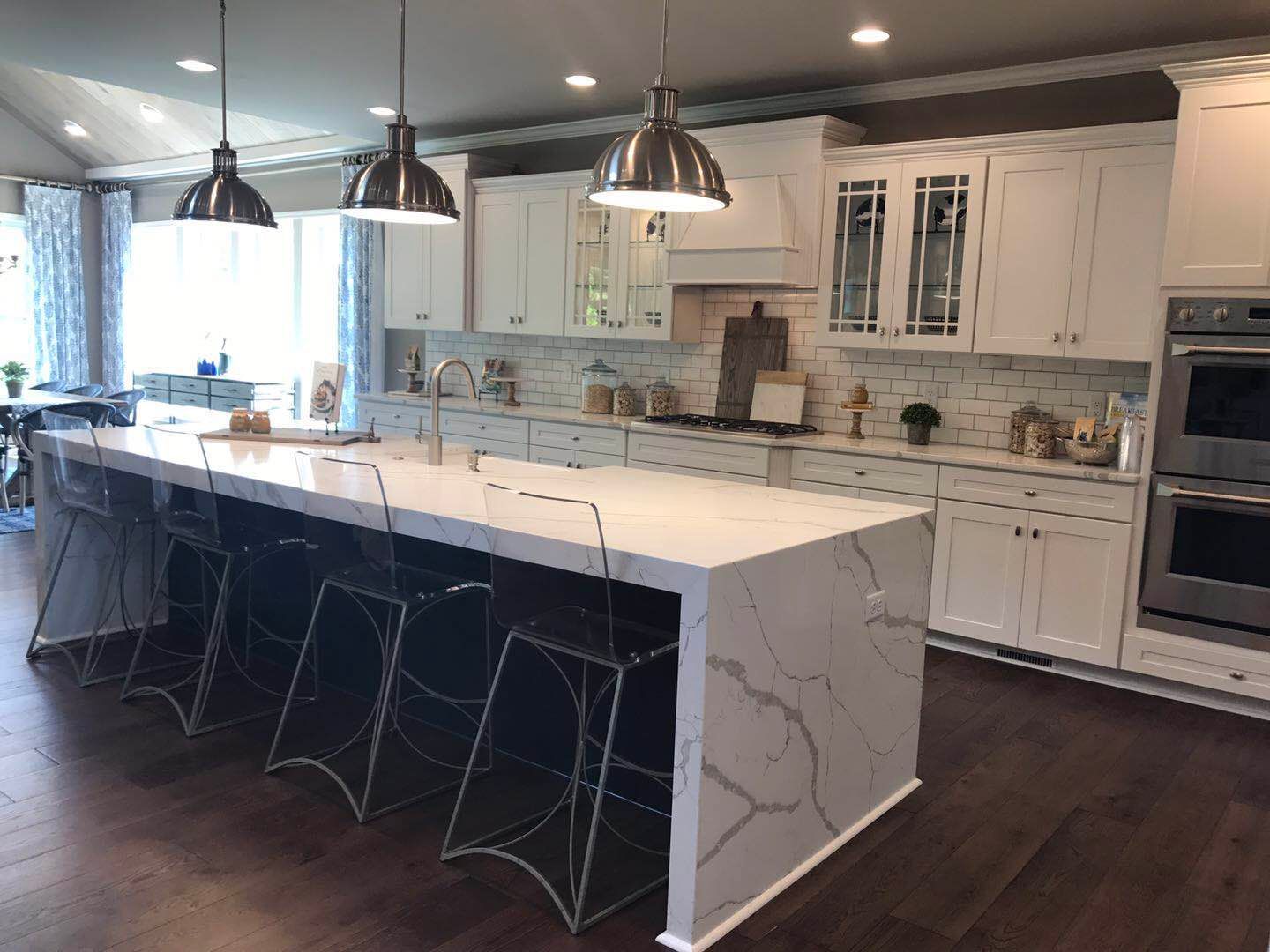 There is a large island in the middle of the kitchen.
