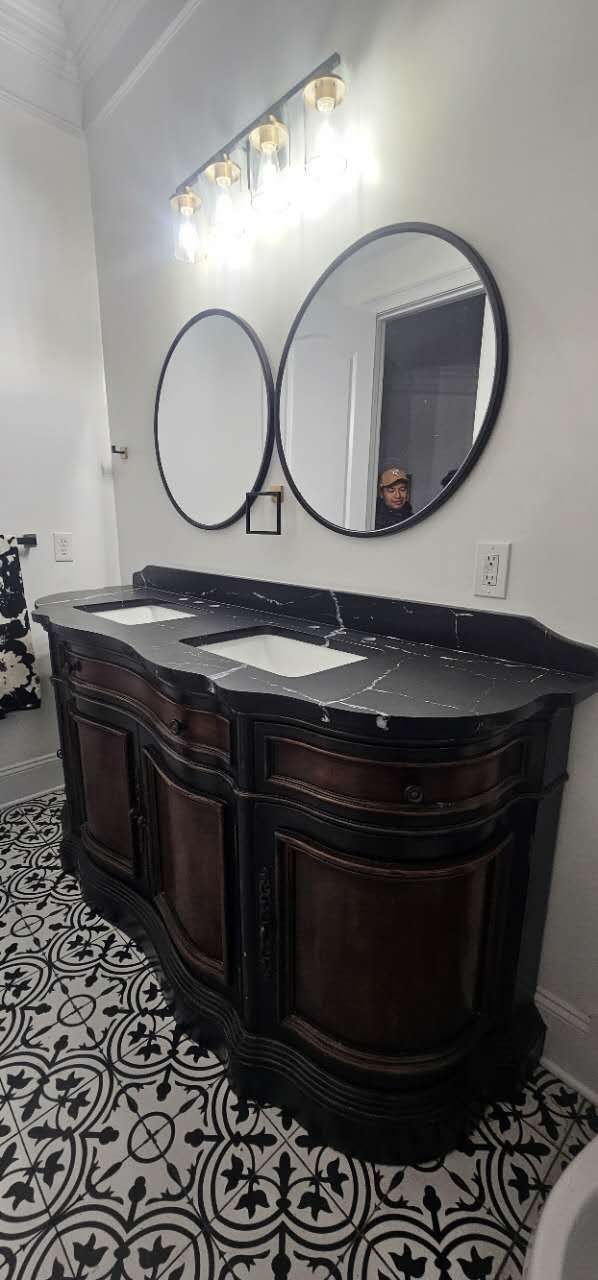 A bathroom with two sinks and two mirrors.