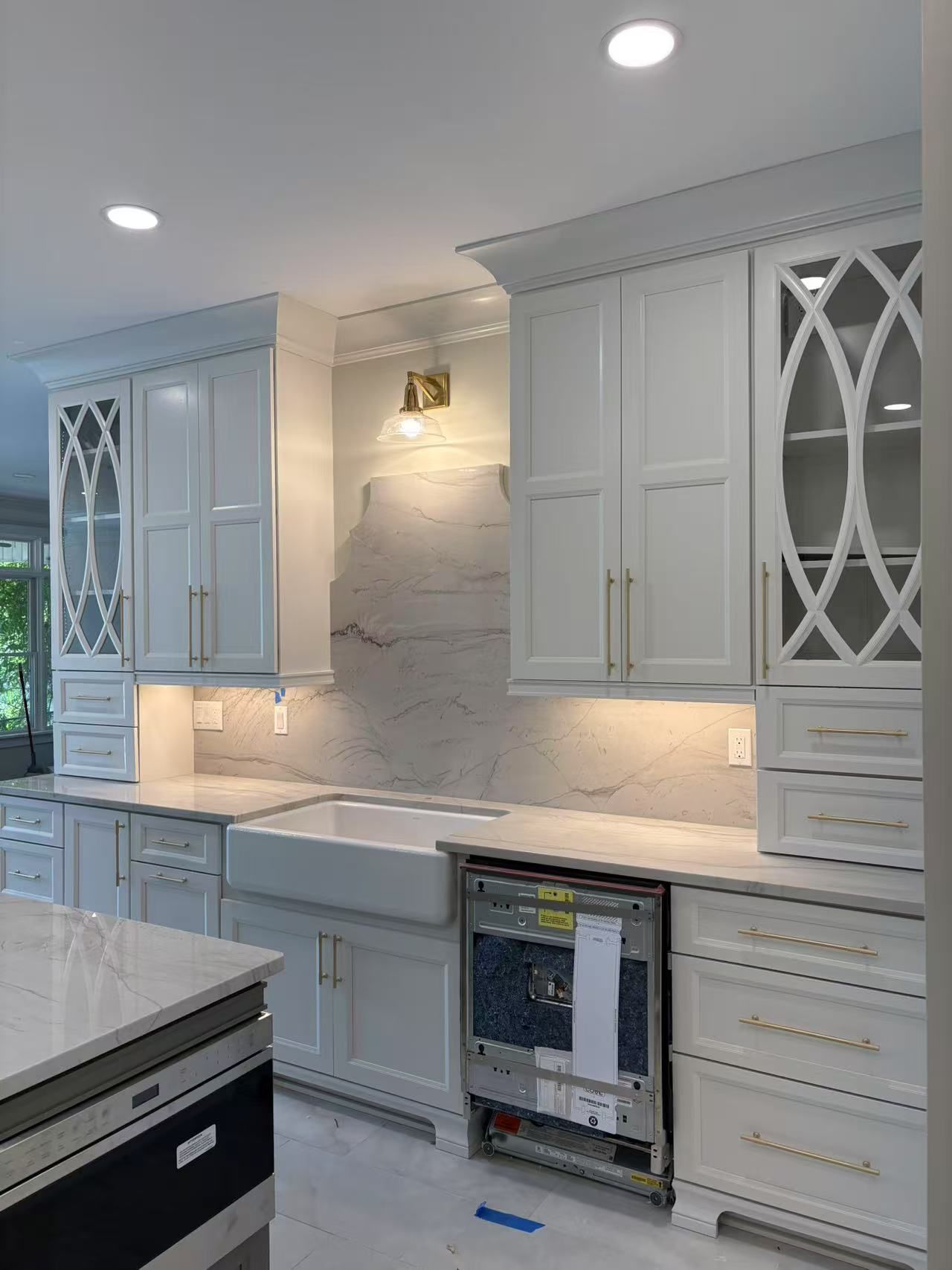 A kitchen with white cabinets, stainless steel appliances, and a sink.
