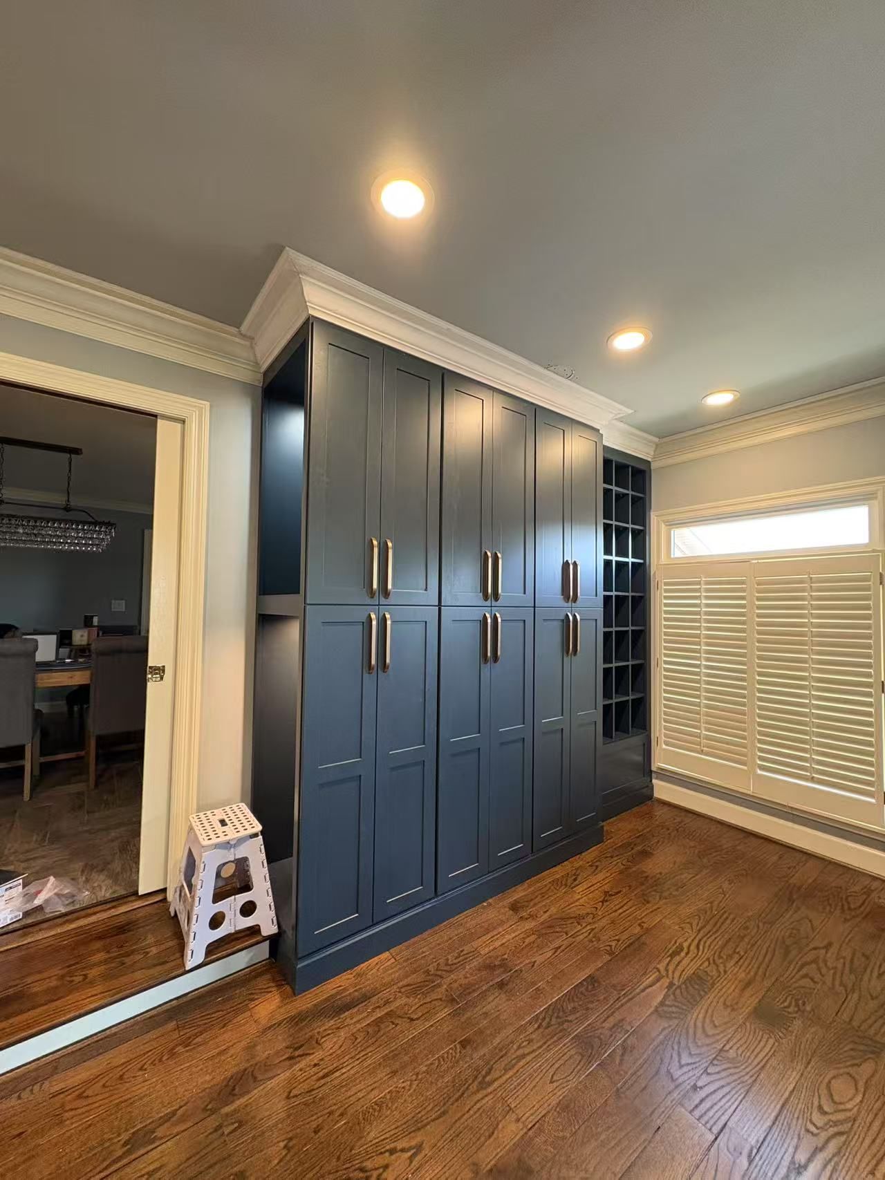 A large room with lots of cabinets and hardwood floors.