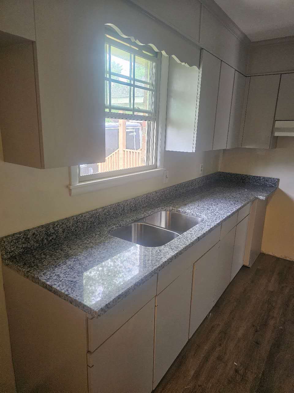 A kitchen with granite counter tops and a sink.