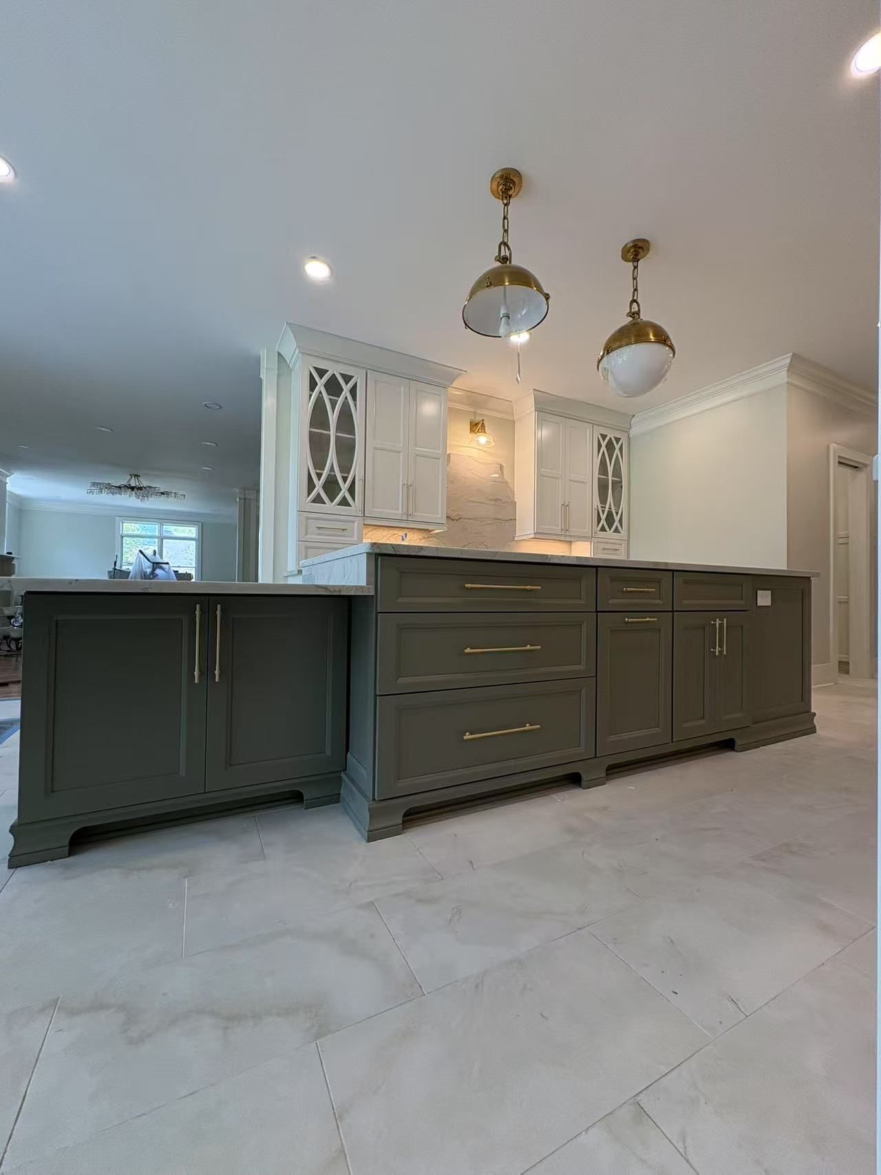 A kitchen with a large island and lots of cabinets and drawers.
