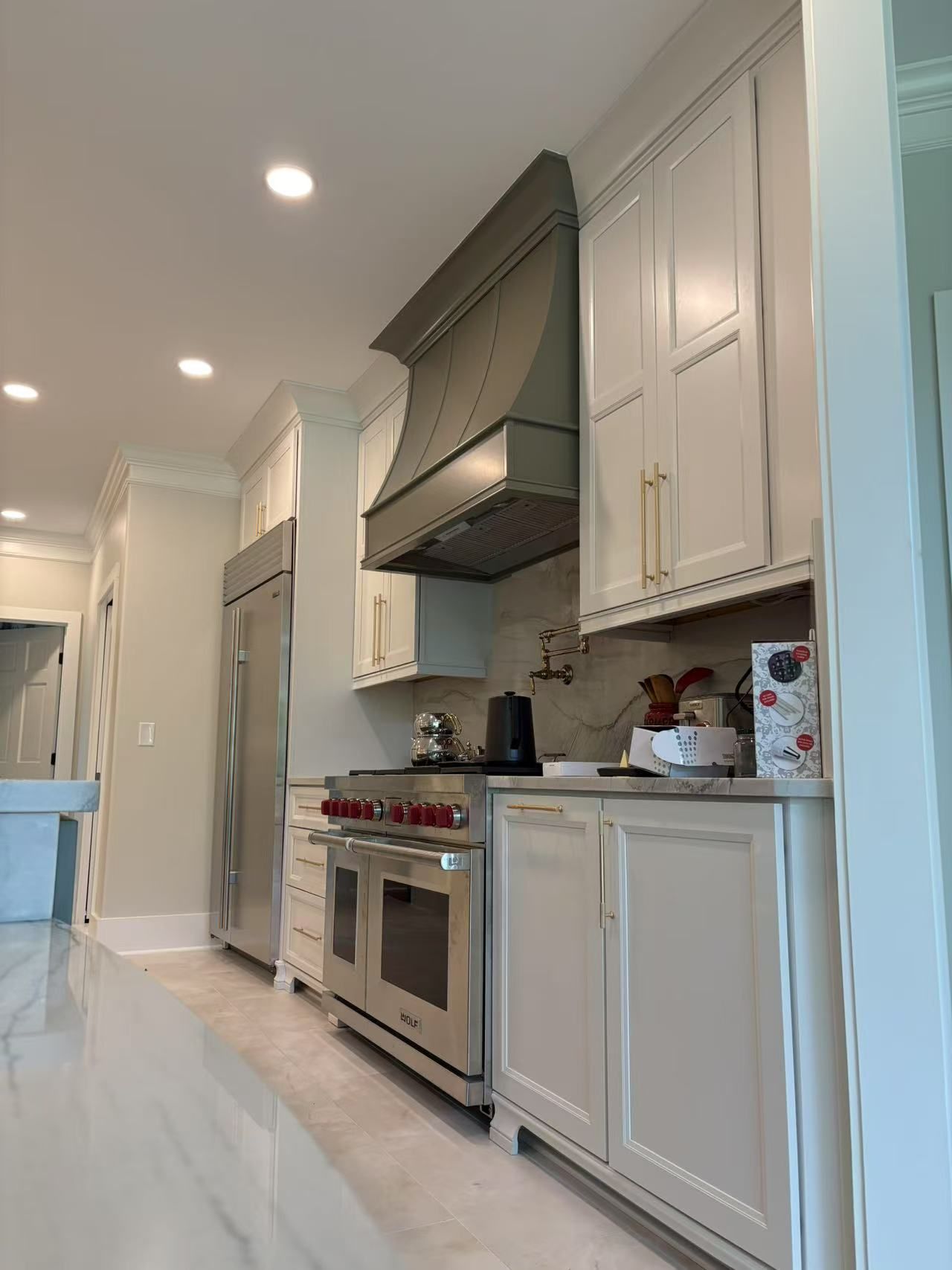 A kitchen with white cabinets and stainless steel appliances.